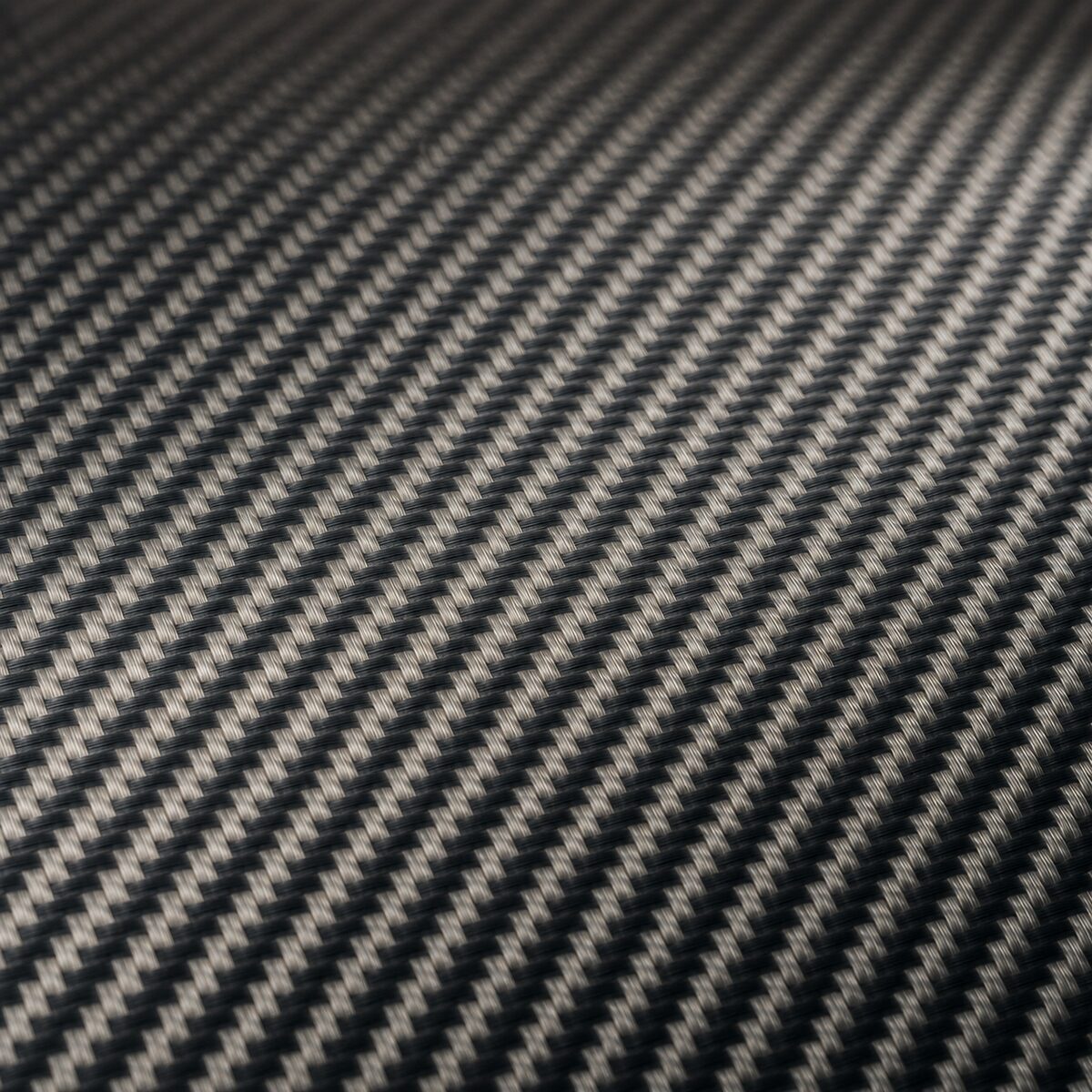 Tejido de fibra de carbono impregnado con resina visto en macro, con trama continua y reflejo controlado.